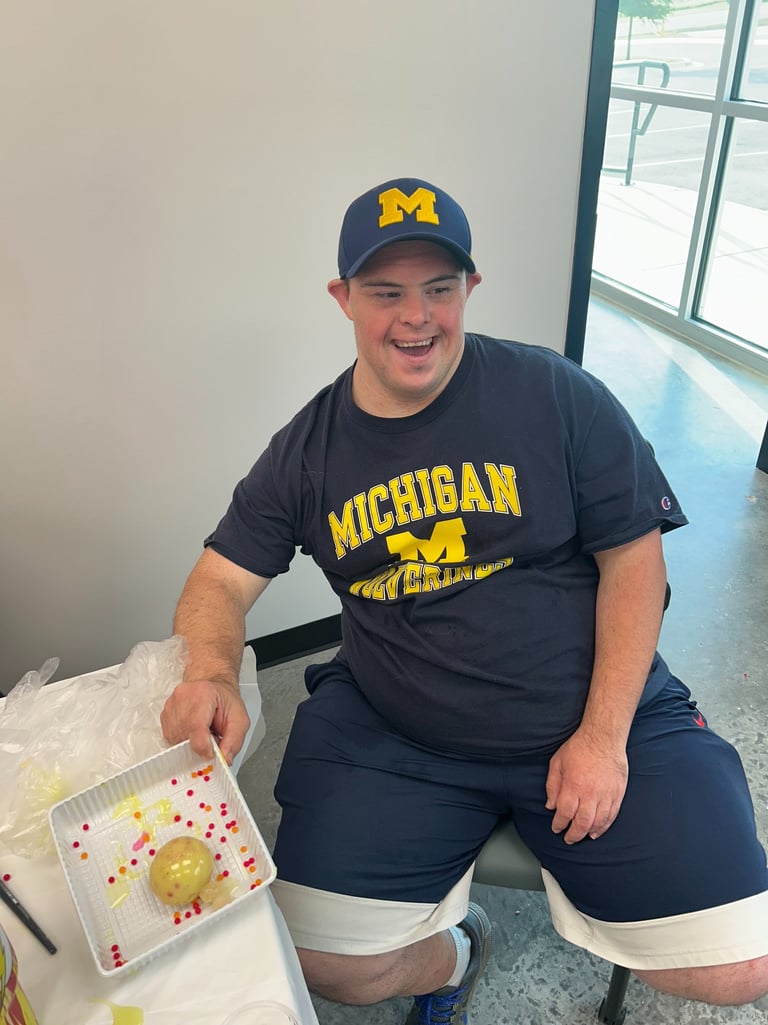 a man sitting at a table with a tray of food