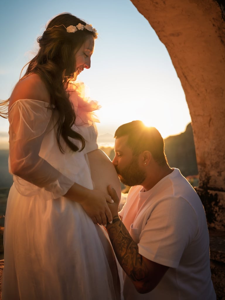 a pregnant woman is holding her belly while a man is holding her belly