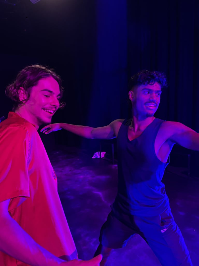 two men standing in front of a stage