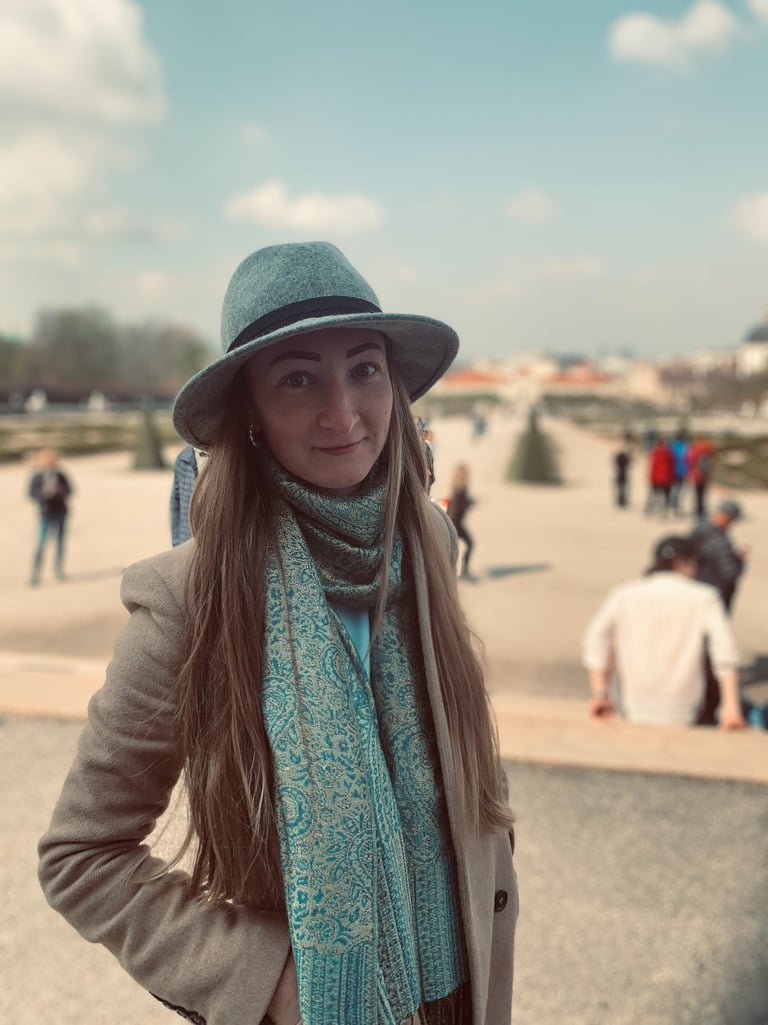 a woman in a hat and scarf on a sunny day