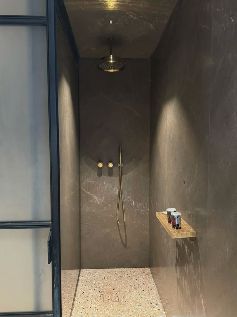 A modern and luxurious bathroom featuring multi-coloured microcement