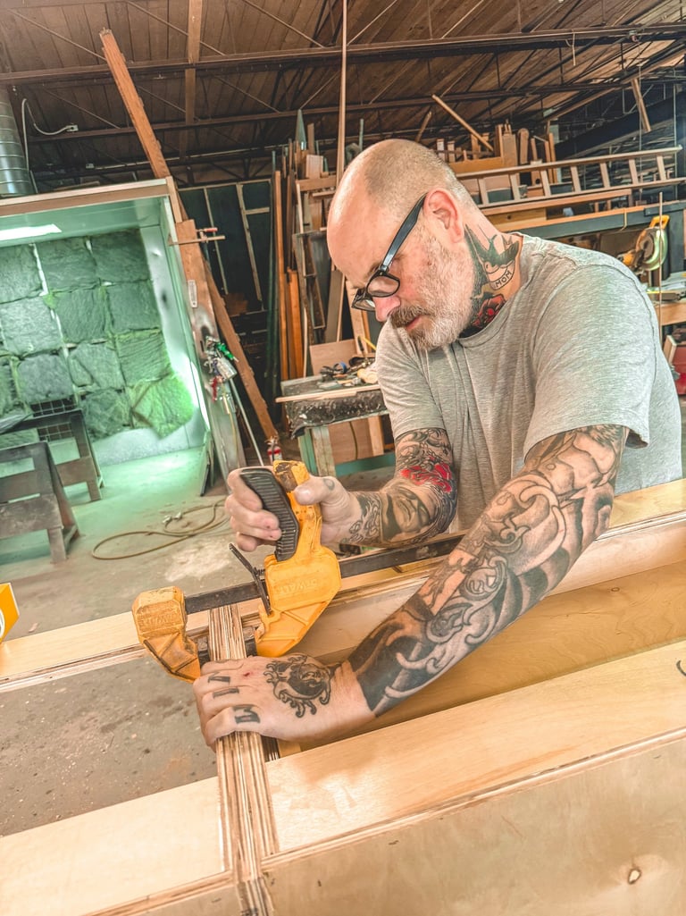 Master craftsman creating artisan woodwork in a Detroit workshop.