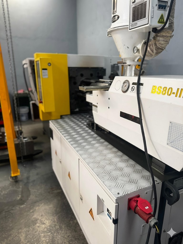 Industrial plastic injection molding machine model BS80-II in a manufacturing facility.