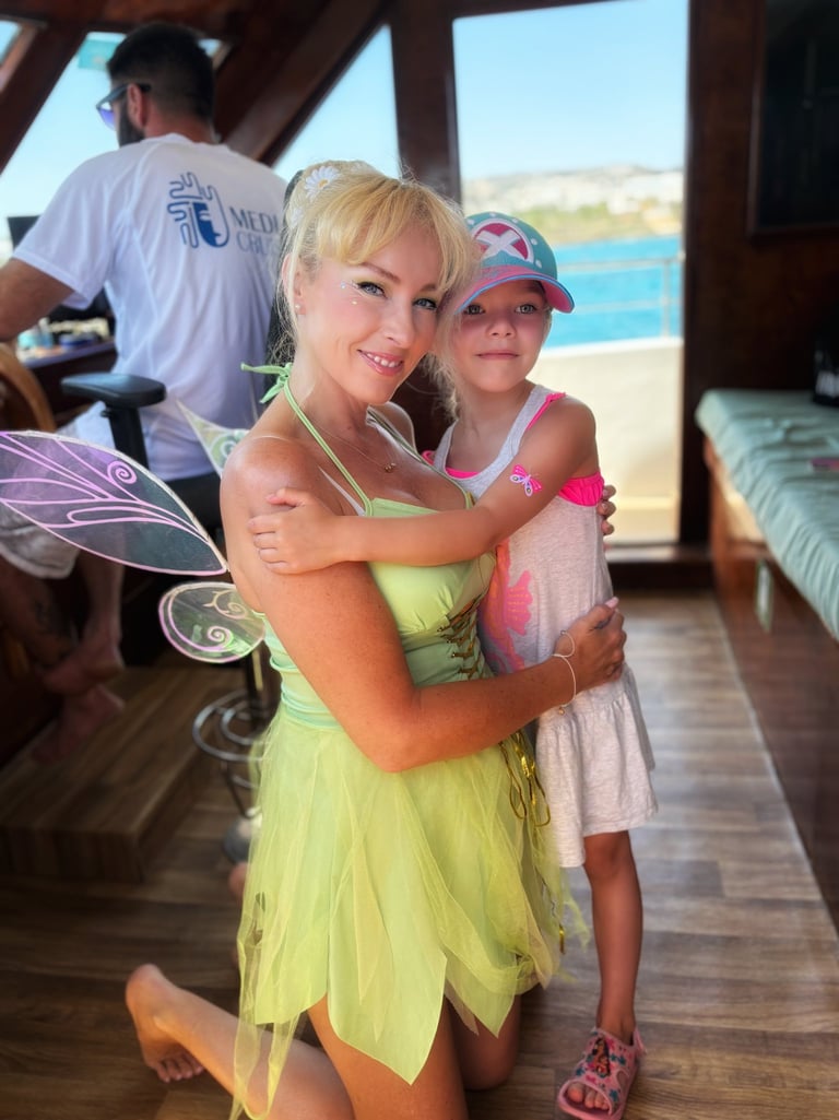 Fairy performer with a child guest on a family boat tour in Cyprus