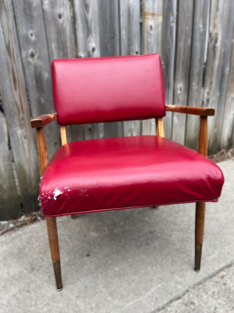 red vinyl vintage chair with edge damage