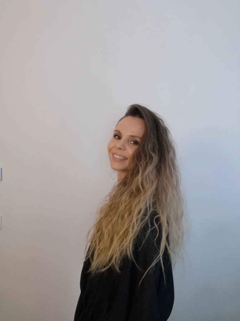 Christine Hauser, certified RTT Practitioner, smiling in a relaxed portrait against light background