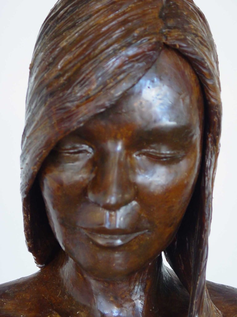 wax detail of a woman's face with long hair 