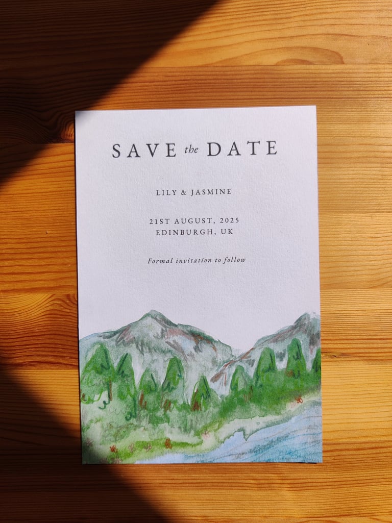 a save the date with an illustration of a mountain