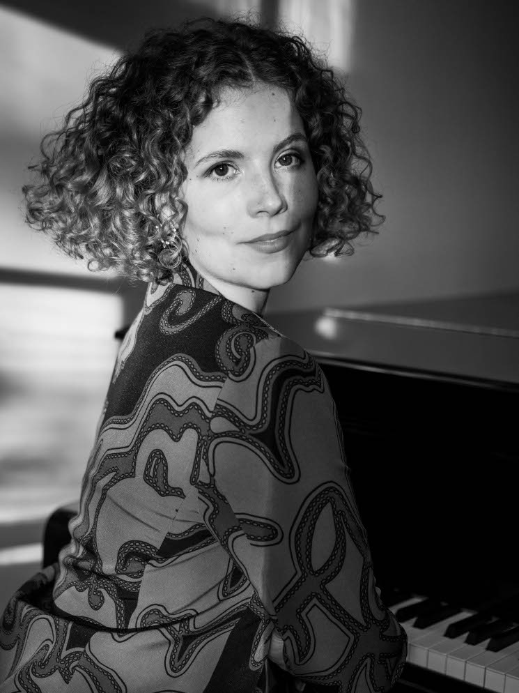 a woman iportrait and a piano