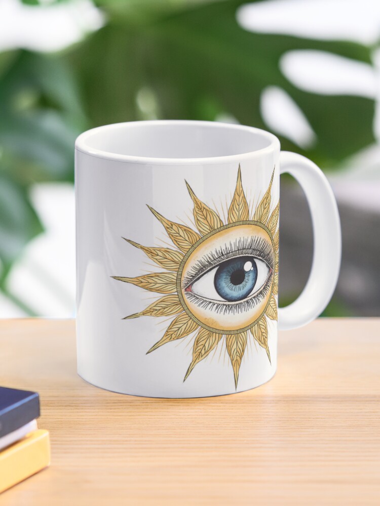 Ceramic mug featuring a vintage mystical sunburst eye design.