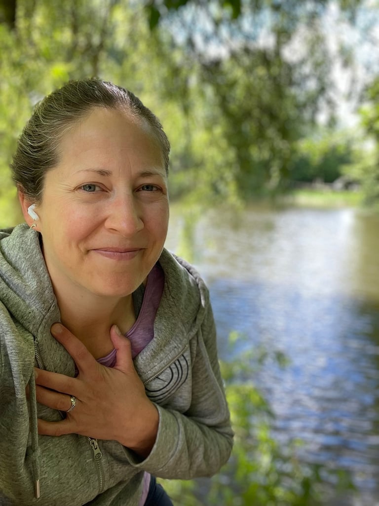 a woman with a gray jacket and a pink shirt