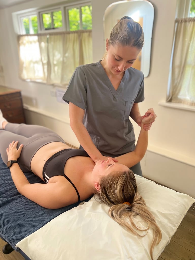 osteopath assessing patient and providing treatment in clinic room