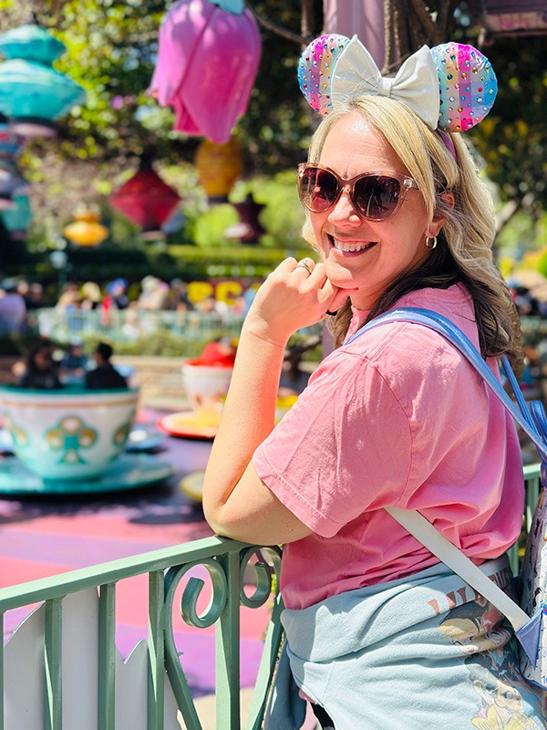 Emily Brisson pictured in front of the Mad Tea Party teacups at Disneyland® Park.