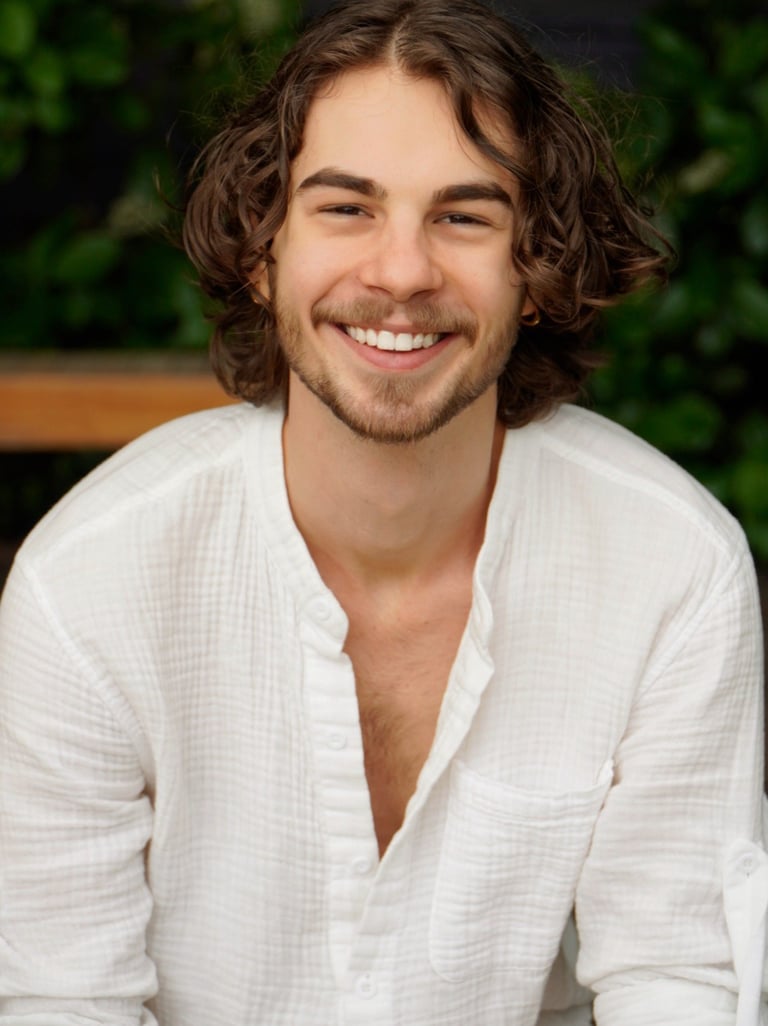 a man with a beard and a white shirt