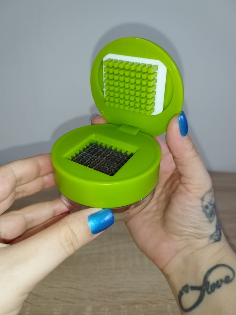 Joie green garlic press and chopper with stainless steel blades and built-in storage container