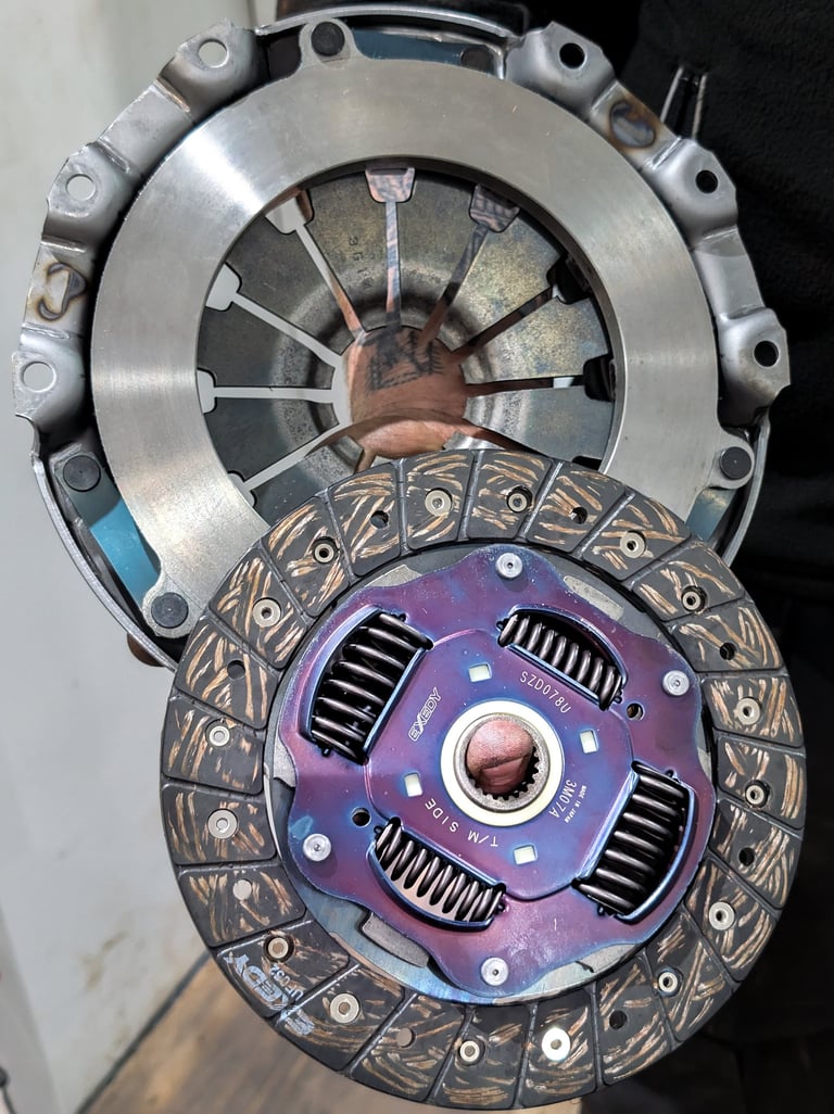 A high-performance Exedy clutch disc and pressure plate kit for automotive transmission repair.