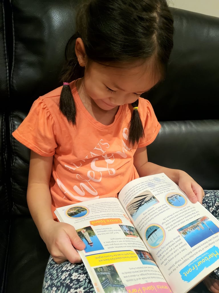 Toronto city guide & journal in child's lap