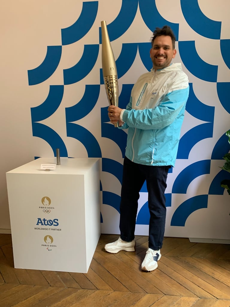 Tim Dougill holding the Paris24 Olympic torch.