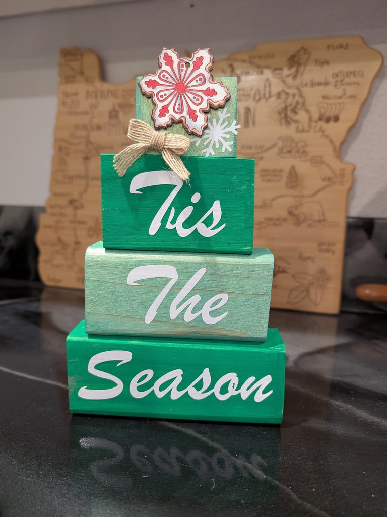 Rustic green wooden block stack Christmas decoration with Tis the Season script and snowflake topper.