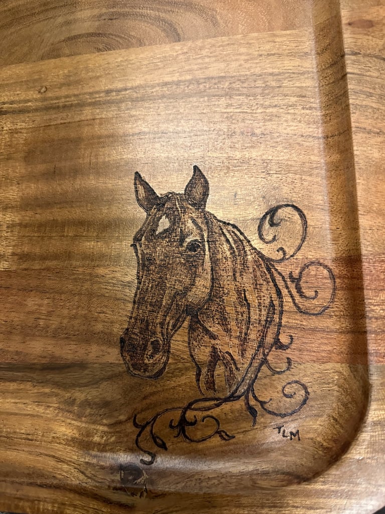 Rustic wood-burned horse head portrait on a handcrafted wooden tray with decorative scrollwork.