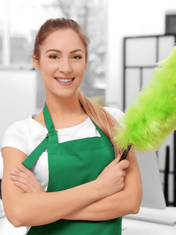 a woman in a green apron and aprons holding a green duster