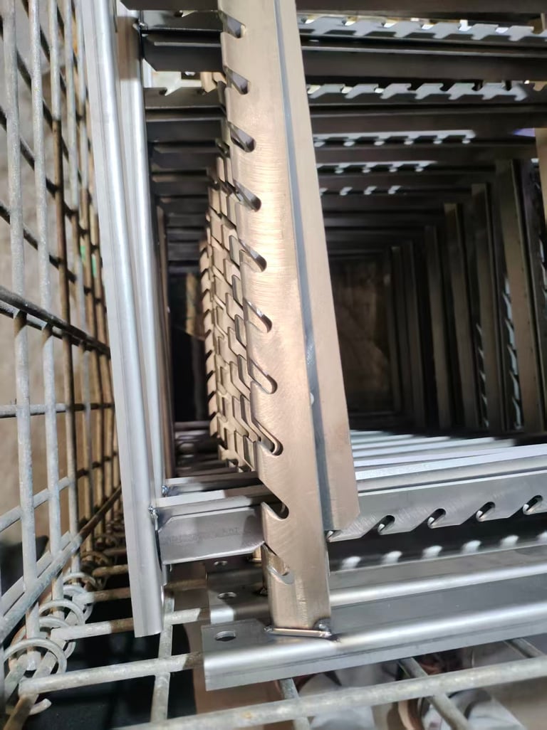 Stacked industrial stainless steel shelf supports with notched adjustment slots in a storage rack.