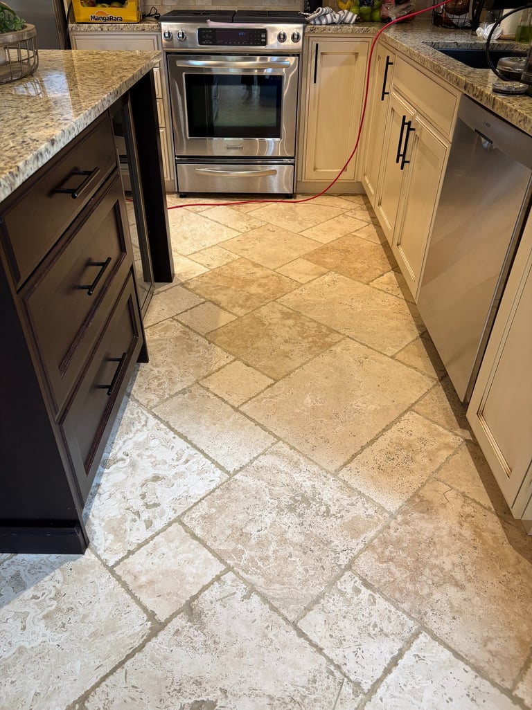 Clean and restored travertine kitchen floor after professional cleaning