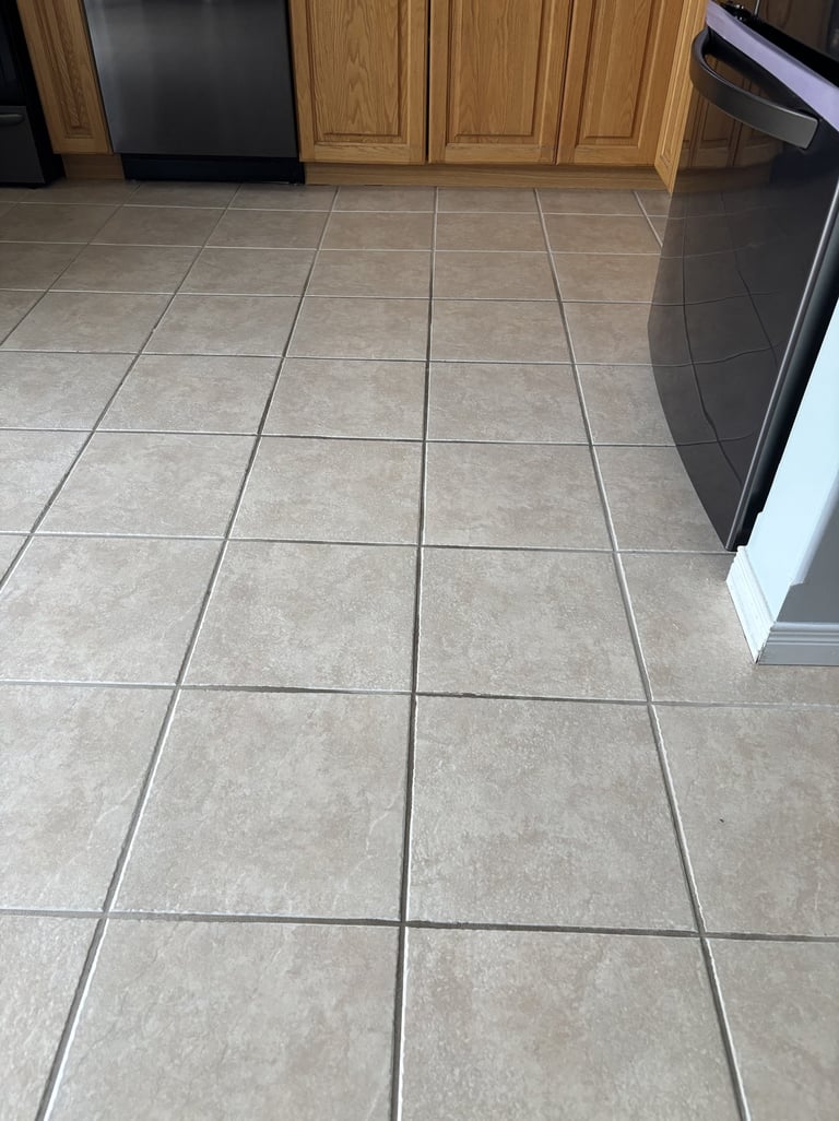 Dirty ceramic tile floor in kitchen before professional cleaning