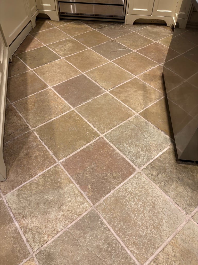 Clean and restored slate tile floor in kitchen after professional cleaning