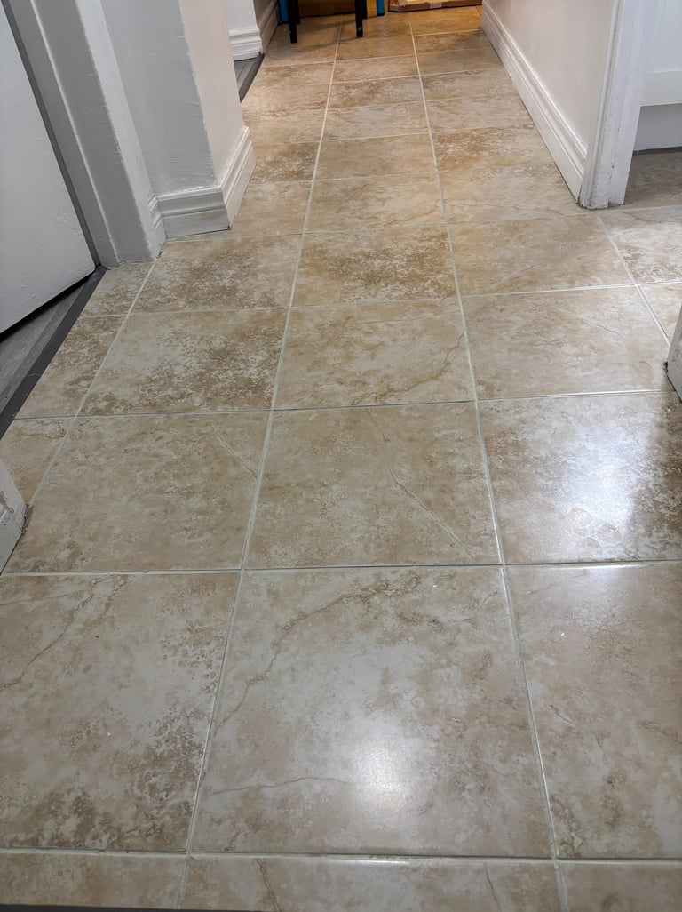 Tile floor being sealed for long-term protection and shine