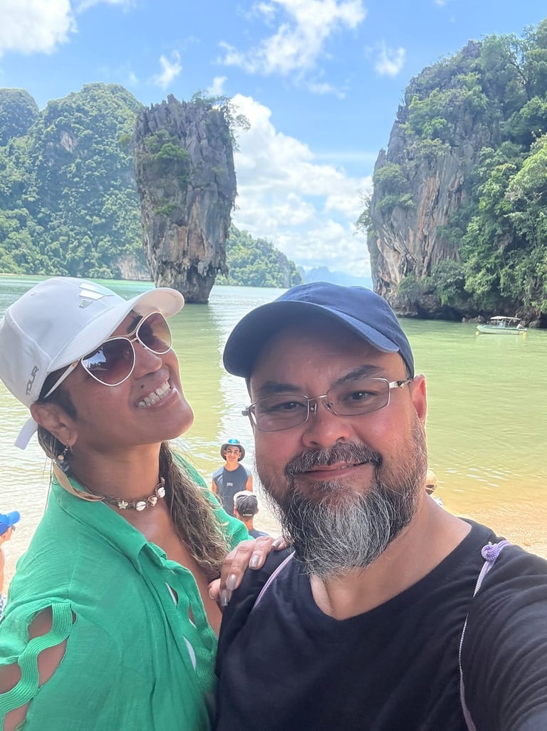 a man and woman standing in front of a boat