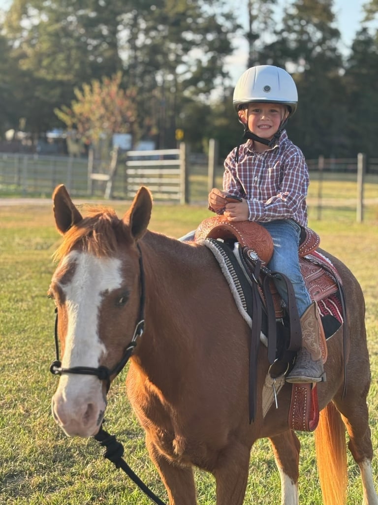 Preschool cowboy riding Snickers at a Birthday Pony Party