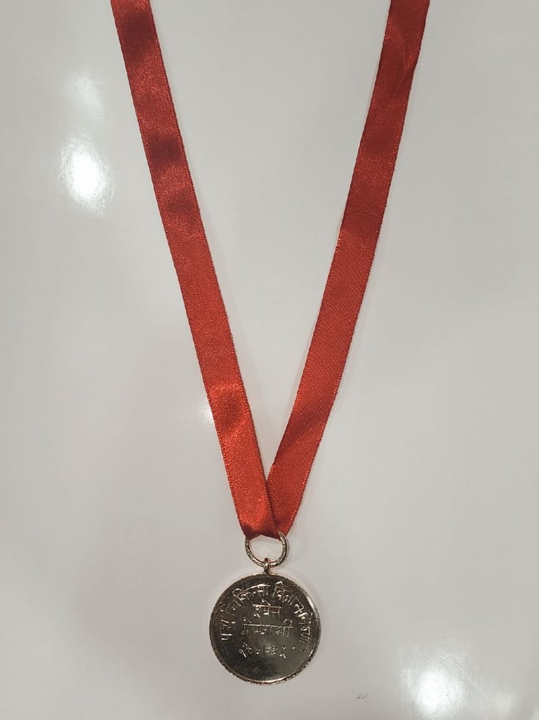Gold medal with a red ribbon symbolizing achievement and excellence.