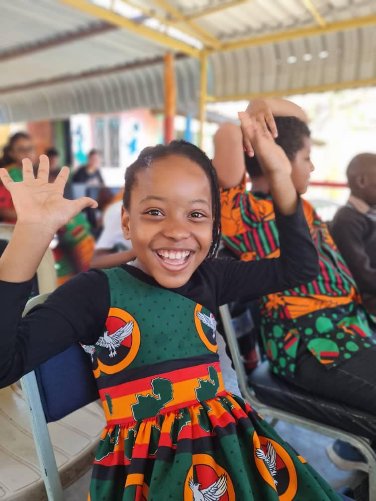 a young girl in a dress with a green dress