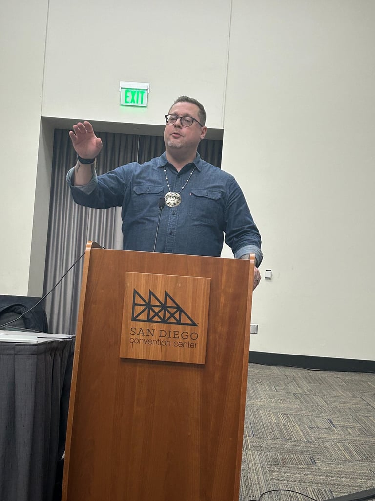 a man standing at a podium with a microphone