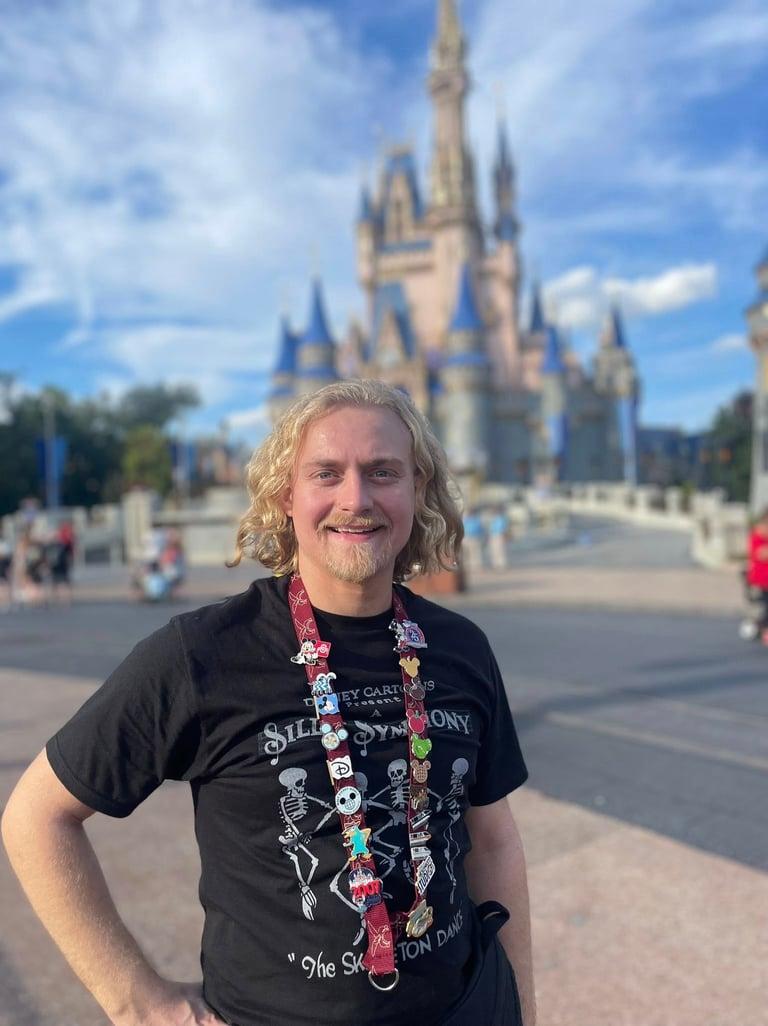 Minnie's Travel Boutique travel advisor Zach Stout pictured in front of Cinderella Castle at Disney's Magic Kingdom® Park.
