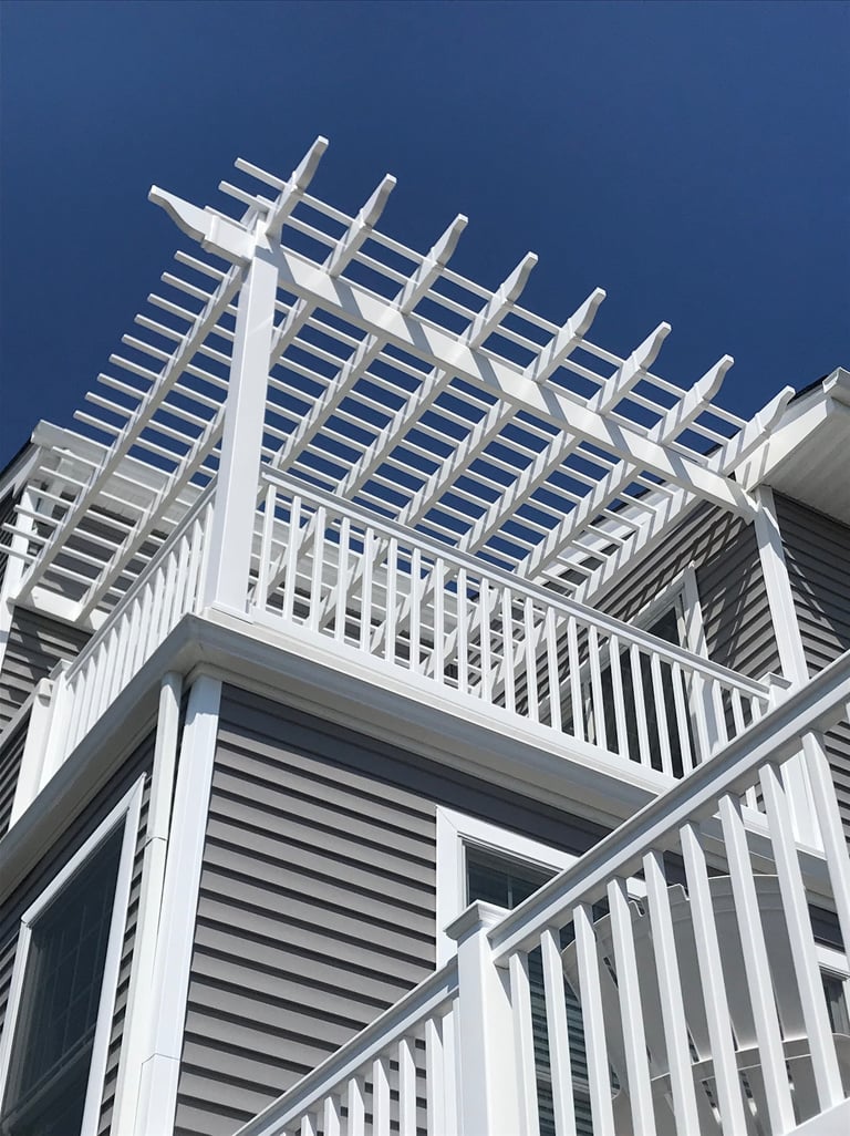 Vinyl pergola system integrated into deck railing