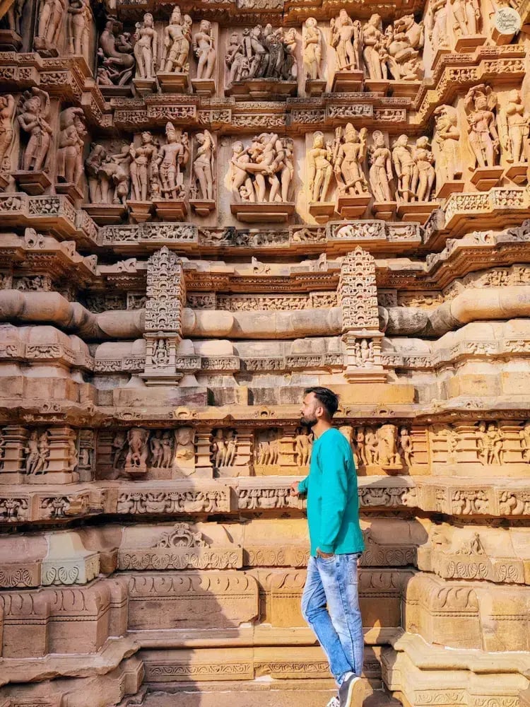 Carvings on Lakshmana Temple, Khajuraho, showing deities, erotic figures, and daily life scenes.
