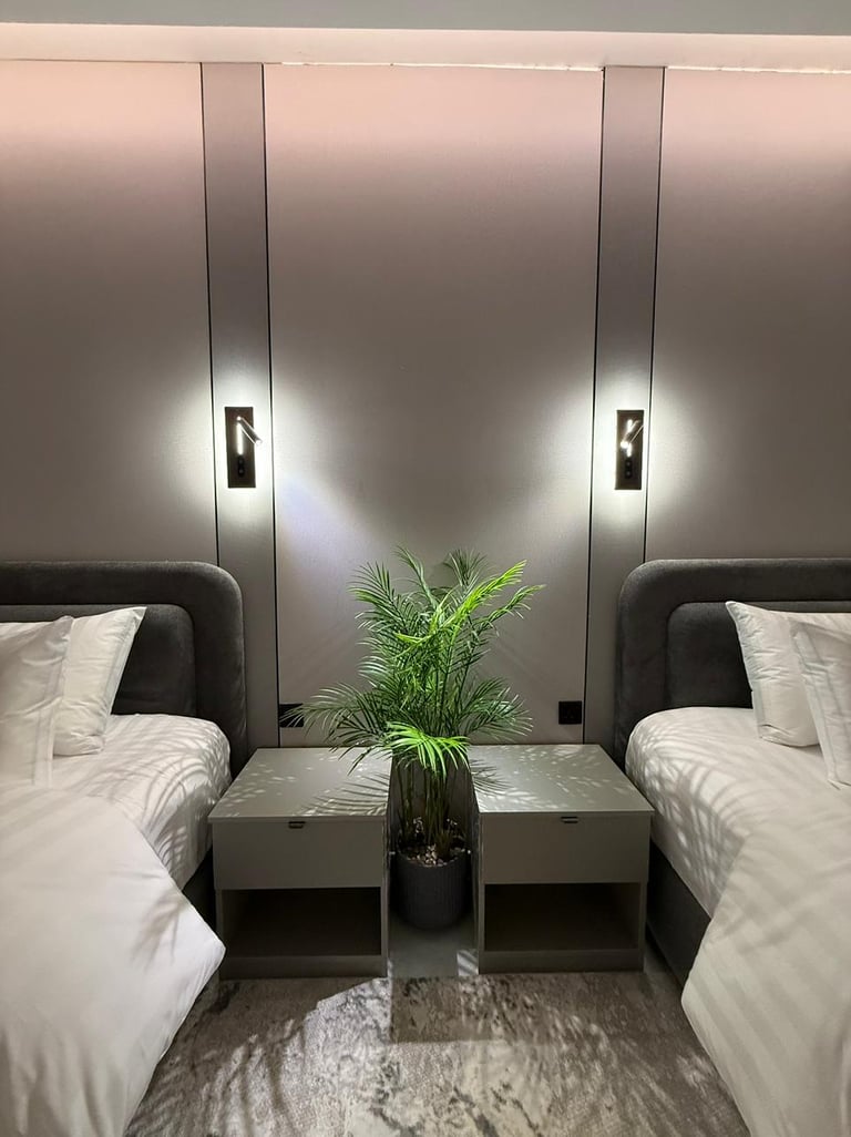 غرفة نوم حديثة بسريرين في شقة مفروشة للإيجار الشهري في جدة