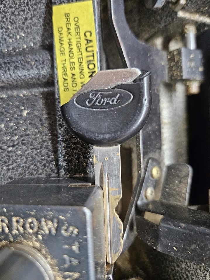 Close-up of a worn Ford car key fob for replacement or duplication