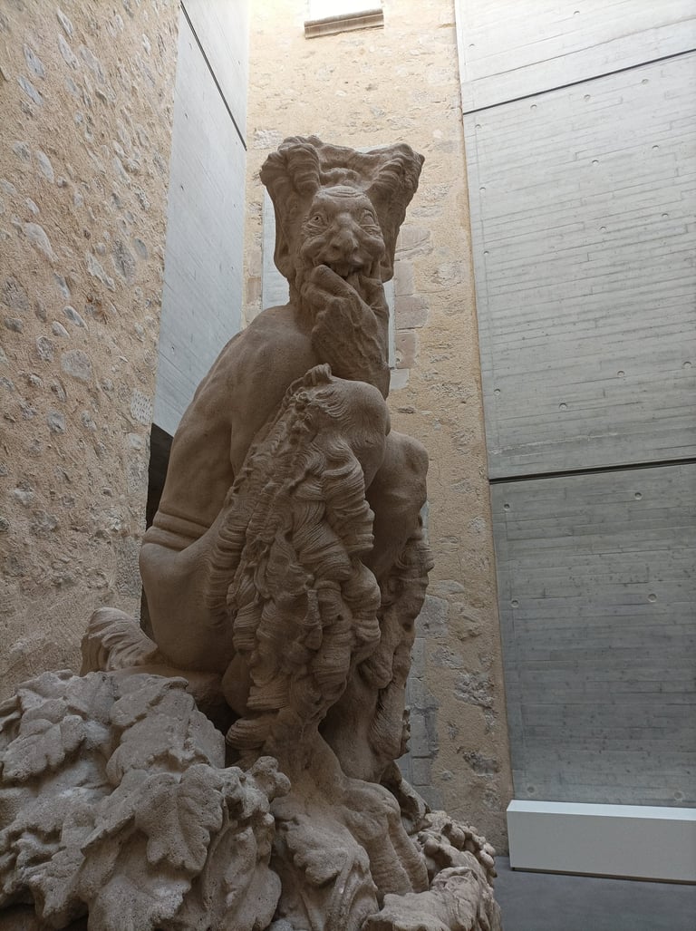 'Le Faune' greets visitors to the Musée Fleury, Lodève, with his wicked grin.