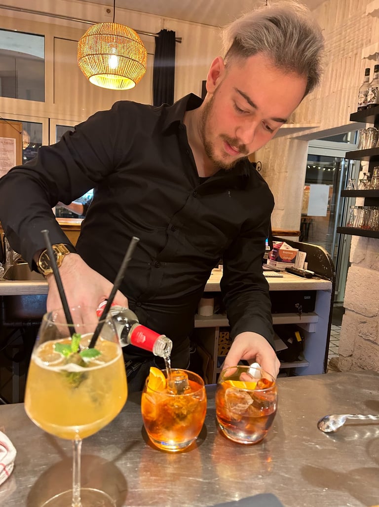 a man in a black shirt is preparing to serve a drink