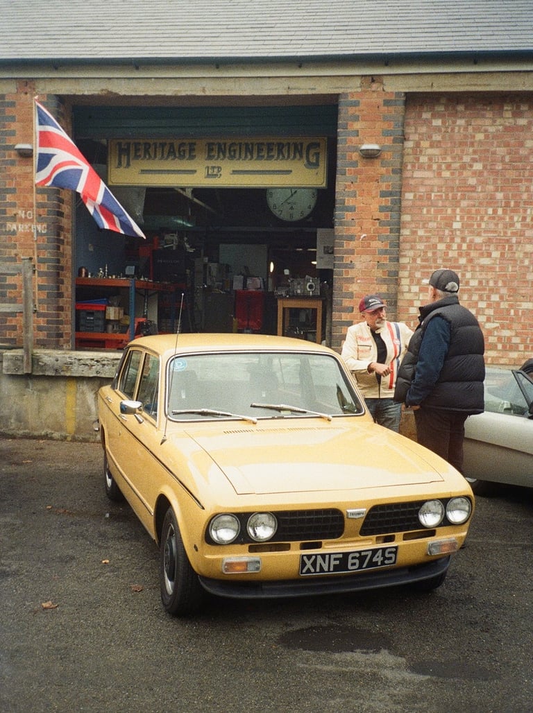 a yellow car parked in front of a brick building