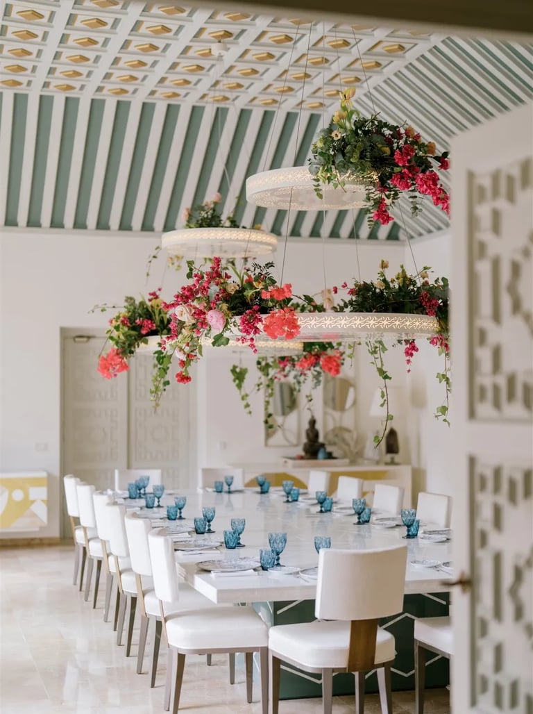 Dining room at Villa El Rincon with chandeliers and floral arrangements