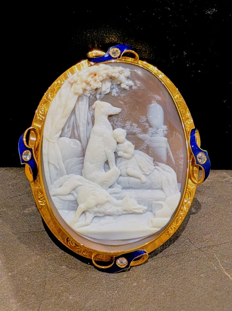 a cameo brooch with gold and diamond frame