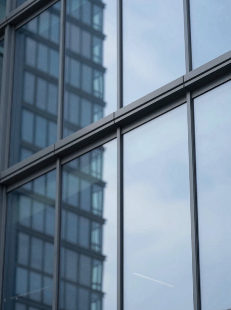 A modern architectural detail of a glass building reflecting a blue sky, representing innovation and vision. The shot is clean and high-contrast, featuring #415A77 and #E0E1DD highlights.
