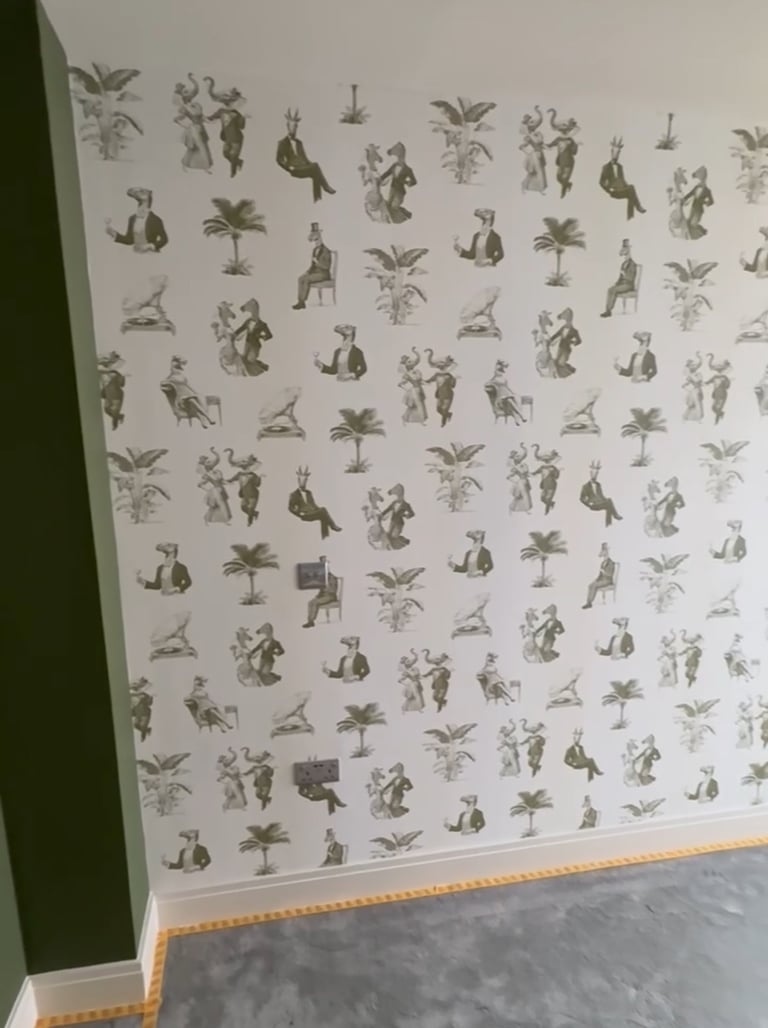 Whimsical wallpaper featuring illustrations of anthropomorphic animals on a white wall in Brighton..