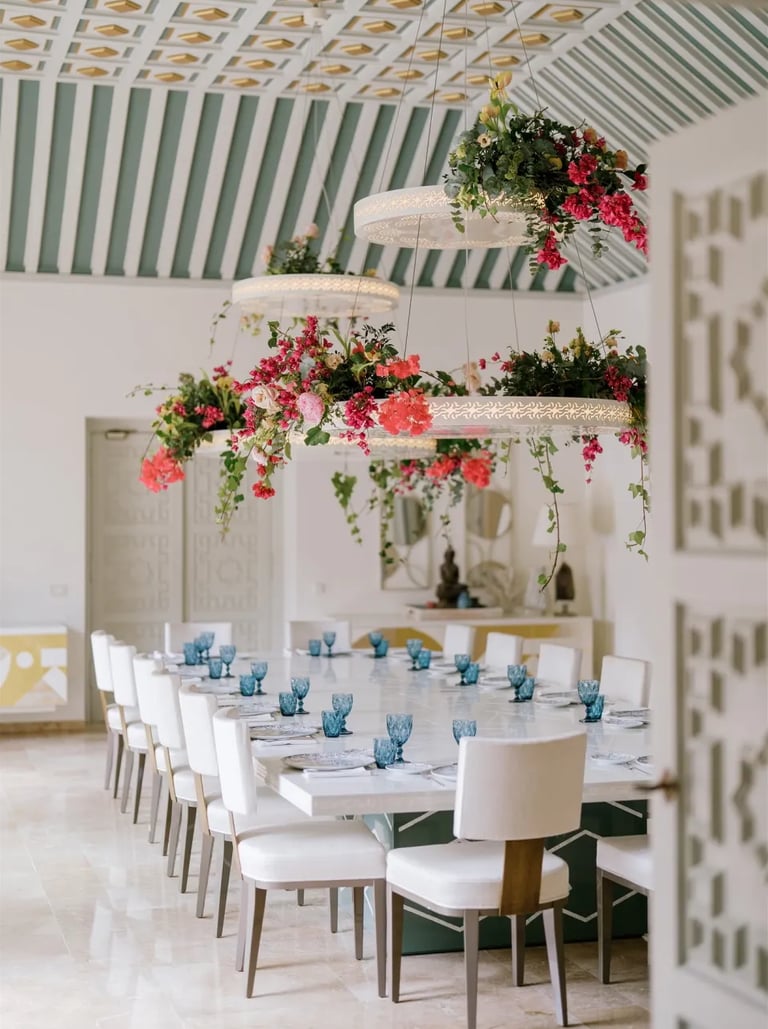 Dining room at Villa El Rincon with chandeliers and floral arrangements