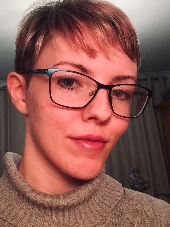 Trans masculine person pre-transition and femme presenting in makeup
