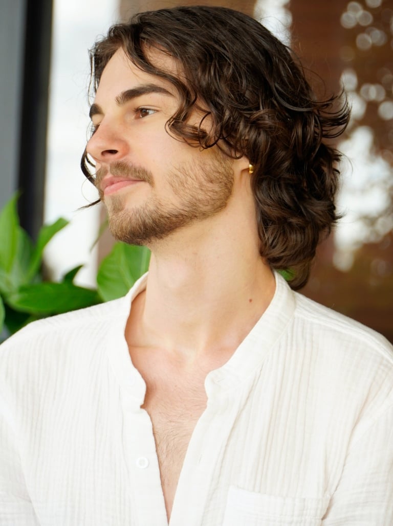 a man with a beard and a white shirt